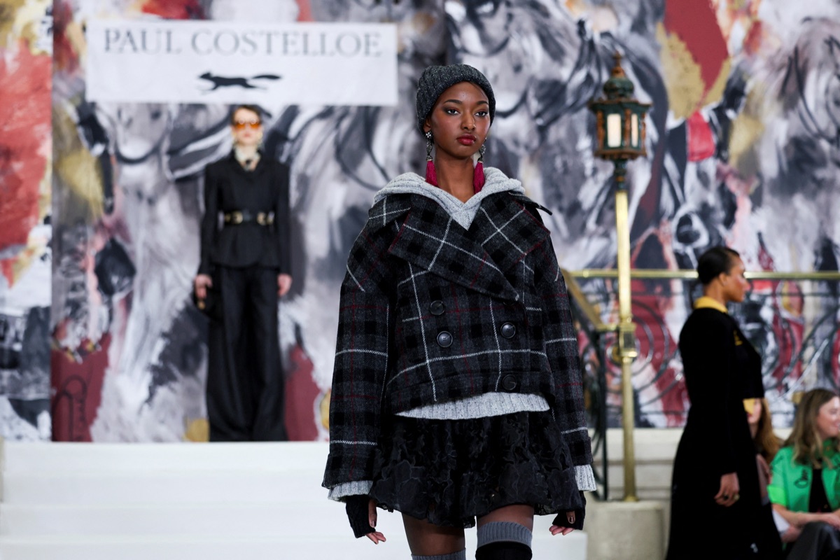 Fashion show backdrop reading PAUL COSTELLOE.