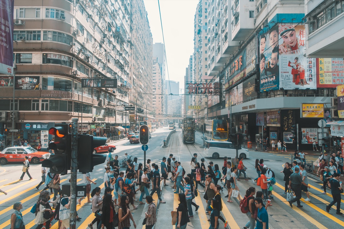 A busy Hong Kong street scene with tiny telephone-number signs.